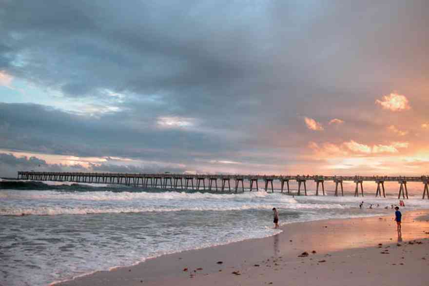 Pensacola-Beach:-Sunset_04.jpg:  fishing pier, sunset, surf, surfers, waves, gulf of mexico, swimmers, bathers, tropical storm, mixed skies