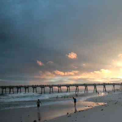 Pensacola-Beach:-Sunset_05.jpg:  fishing pier, mixed skies, surf, bathers, swimmers, tropical storm, mixed skies, gulf of mexico