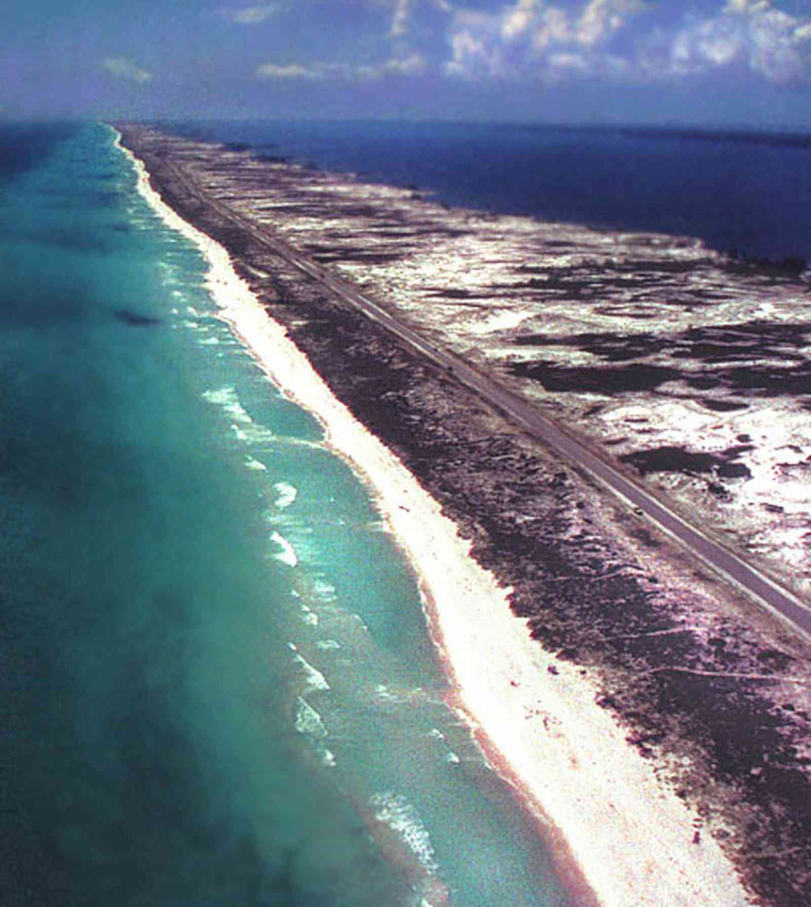 Pensacola-Beach:-Waterfront_10.jpg:  santa rosa island, gulf of mexico, seashore, dune, road, white sand, quartz sand crystal, wave, surf, barrier island, santa rosa sound, aerial view