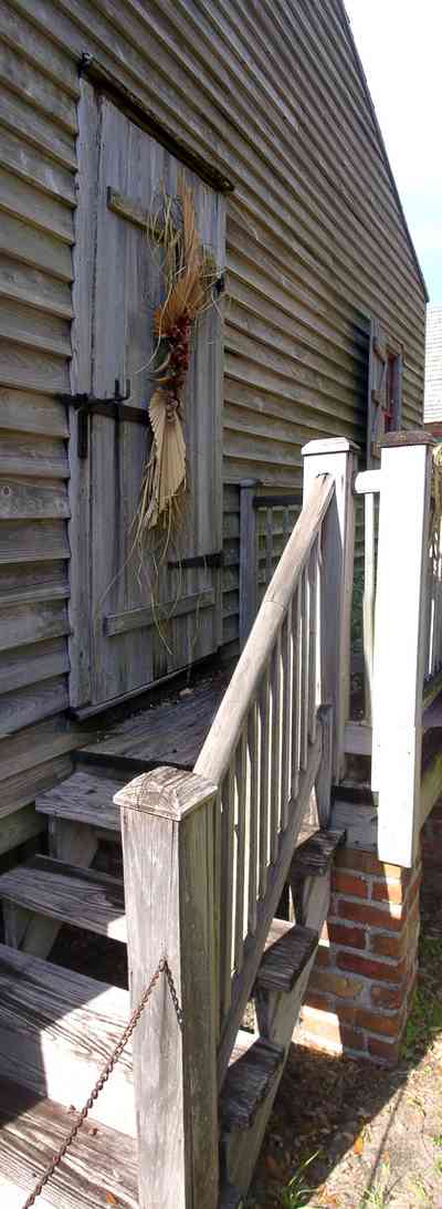 Pensacola:-Historic-Pensacola-Village:-Julee-Cottage_03.jpg:  porch, slave cottage, victorian house, brick pillars, rough wood