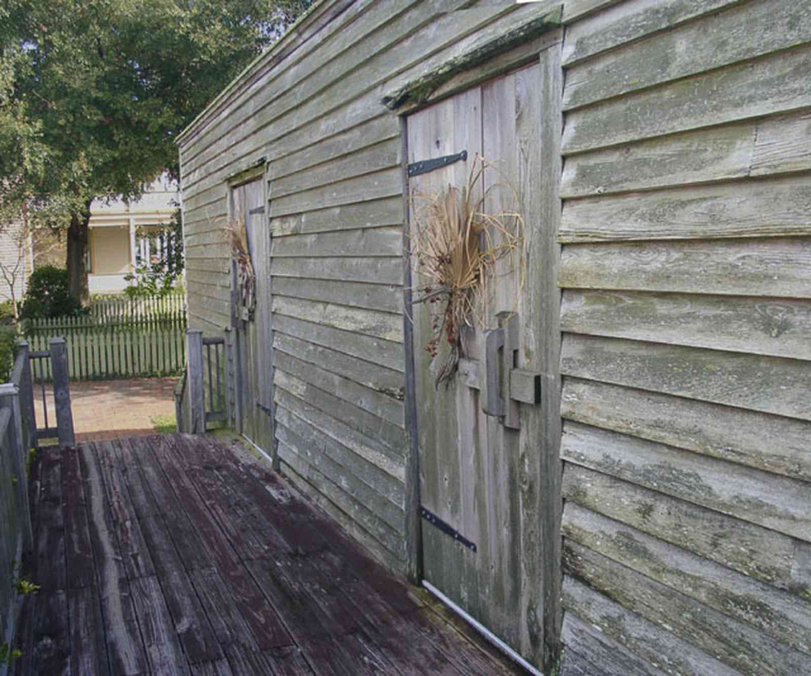 Pensacola:-Historic-Pensacola-Village:-Julee-Cottage_05.jpg:  slave quarters, julee cottage, back porch, rough-hewn wood, deck, picket fence, pensacola historic village