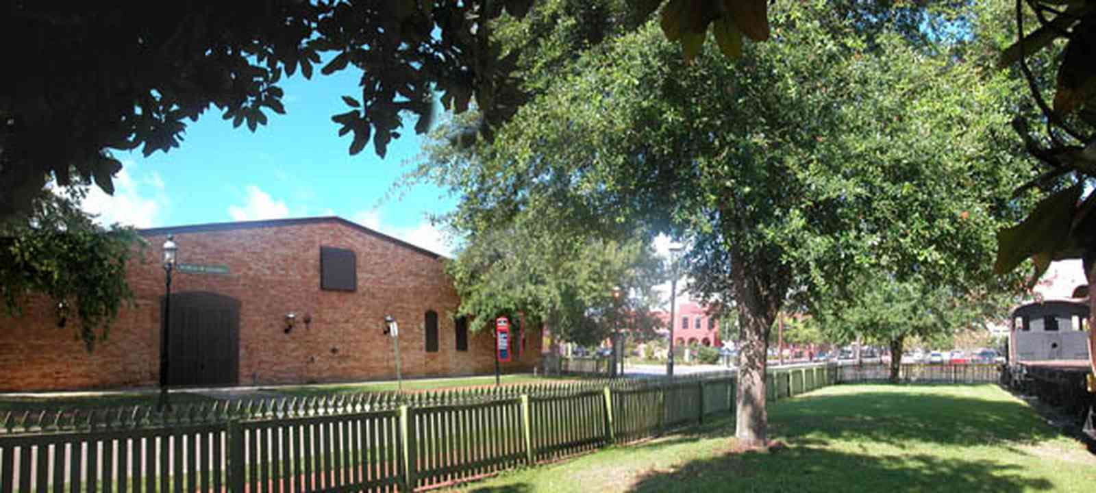 Pensacola:-Historic-Pensacola-Village:-Museum-Of-Commerce_00a.jpg:  museum, train, locomotive, oak tree, village, depot, warehouse