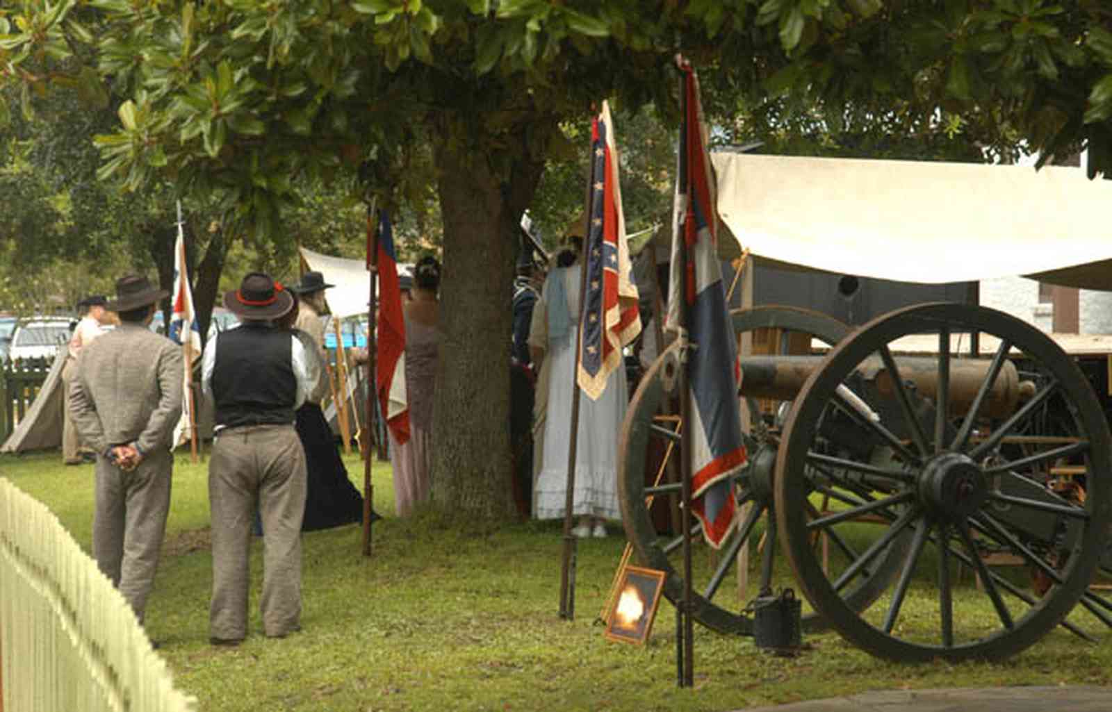 Pensacola:-Historic-Pensacola-Village:-Museum-Of-Industry_01bb.jpg:  historic reenactment, flags, cannon, tent, civil war soldiers, picket fence