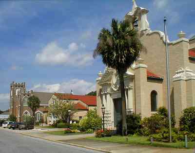 Pensacola:-Palafox-Historic-District:-Christ-Church_03.jpg:  episcopal church, bell tower, spanish revival architecture, crepe myrtle trees, red tile roof, flower garden, 