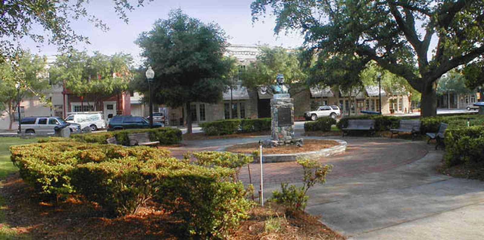 Pensacola:-Palafox-Historic-District:-Ferdinand-Plaza_01.jpg:  town square, plaza, obelisk, stone wall, oak trees, magnolia trees, historic district, courthouse, jackson's restaurant, park bench, empire building