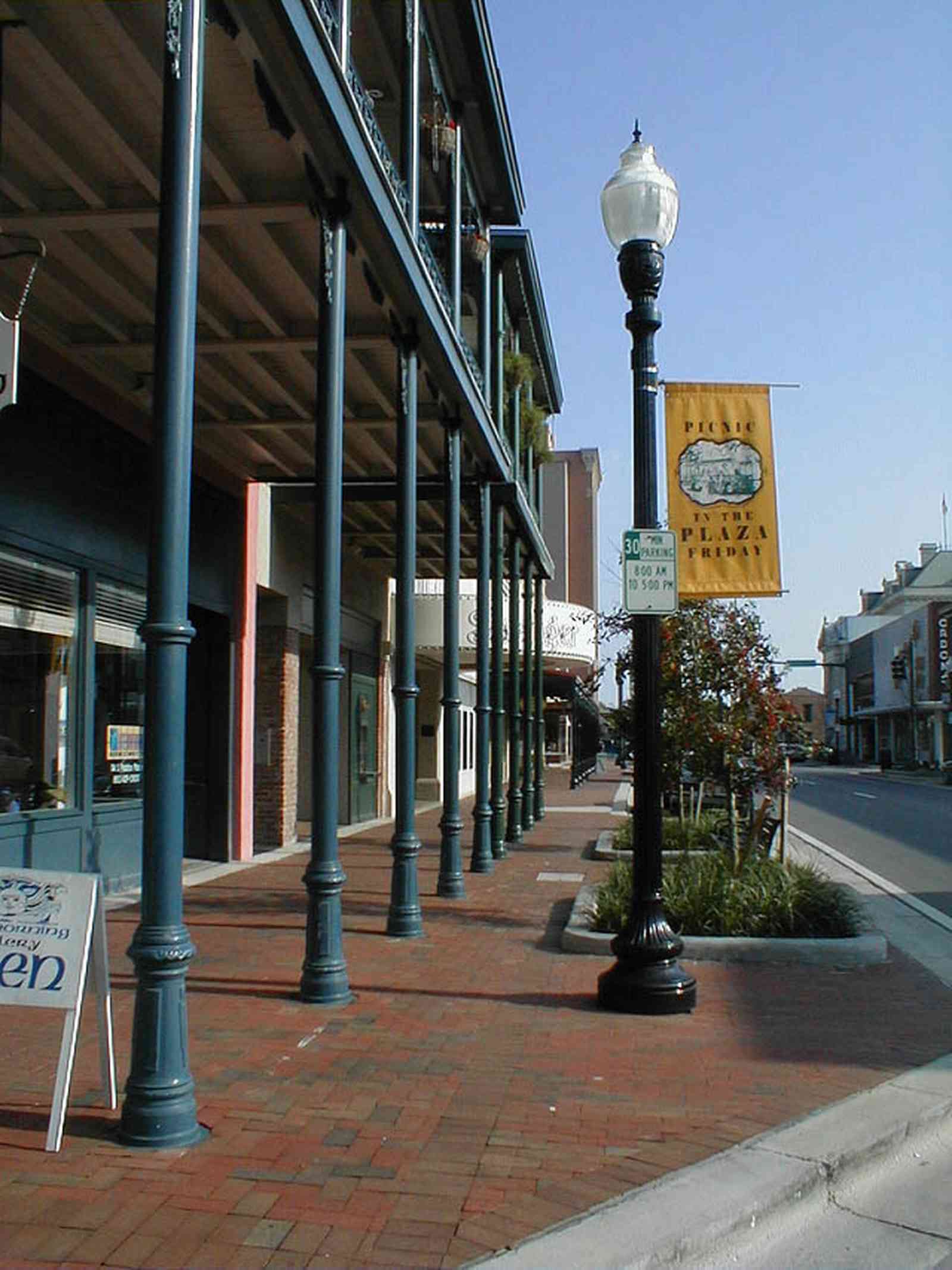 Pensacola:-Palafox-Historic-District:-Saenger-Theatre_01a.jpg:  streetscape, wrought-iron balcony, street lamp, brick sidewalk