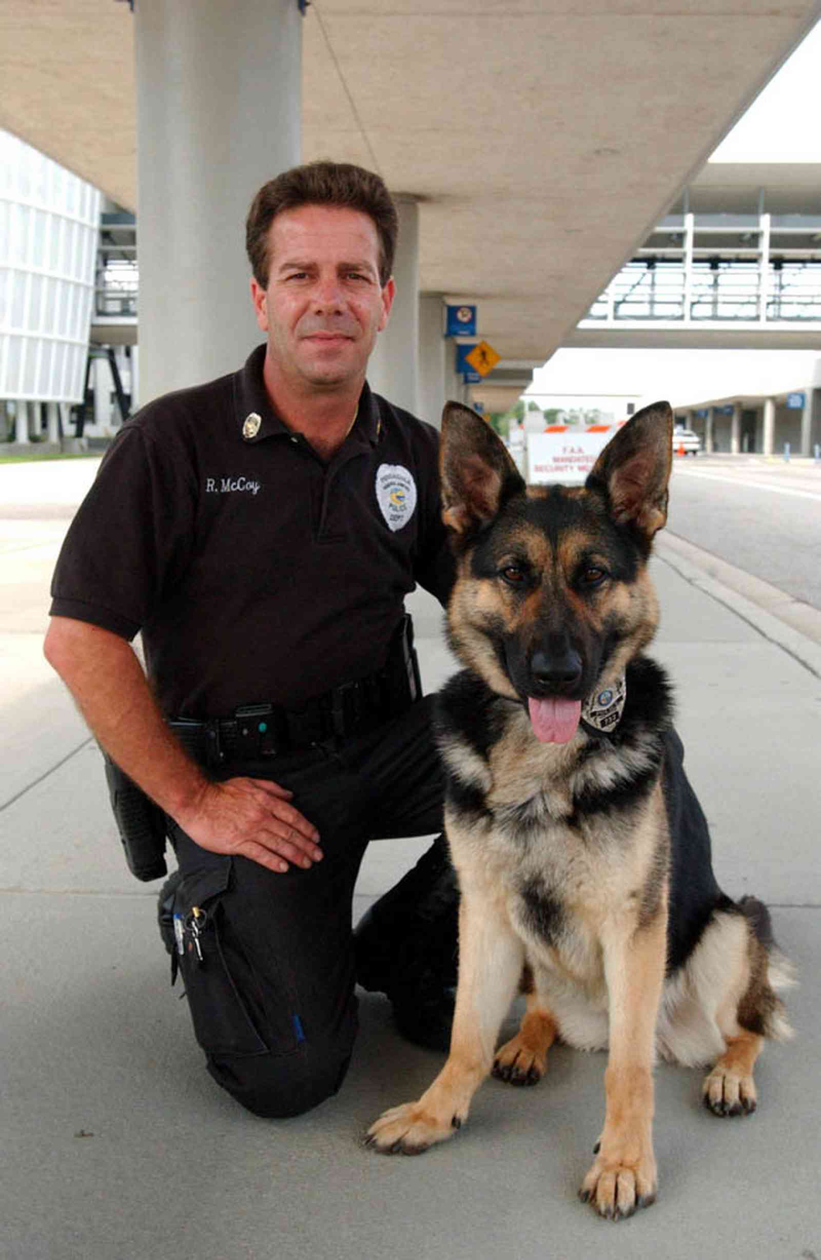 Pensacola:-Regional-Airport_10a.jpg:  explosive ordinance detection dog, police officer, airport, airport security, german shepard, police dog