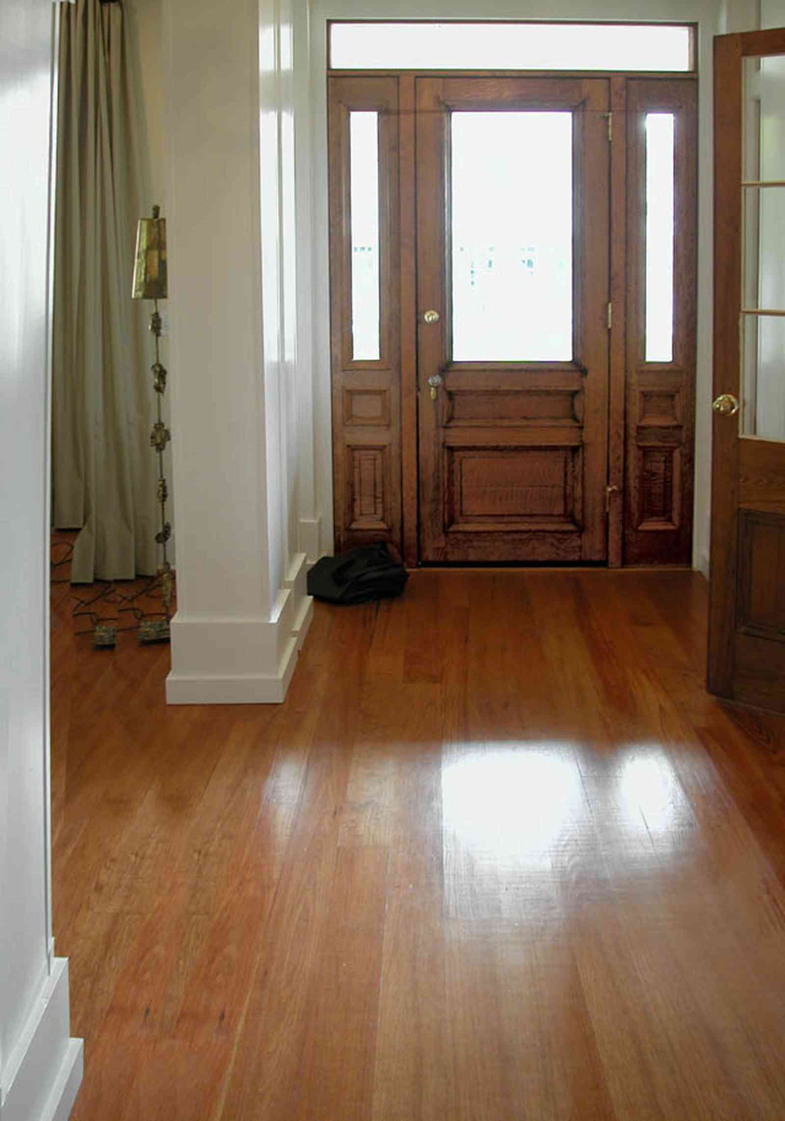 Pensacola:-Seville-Historic-District:-202-Cevallos-Street_05.jpg:  heart pine floors, front door, side lights, transom, front hall, living room