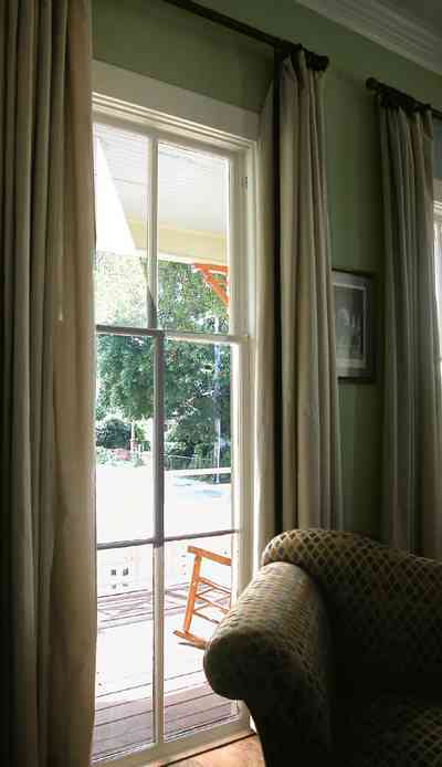 Pensacola:-Seville-Historic-District:-202-Cevallos-Street_08.jpg:  floor length windows, front porch, rocking chair, office, drapes, victorian cottage