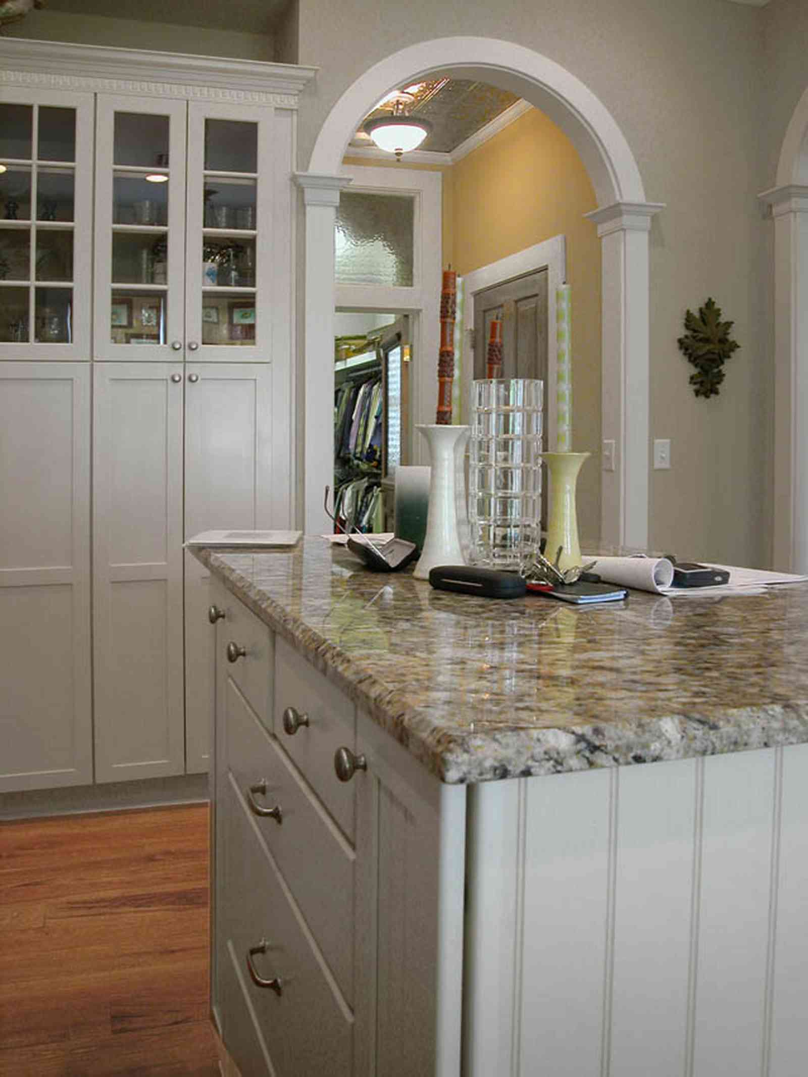 Pensacola:-Seville-Historic-District:-202-Cevallos-Street_16.jpg:  heart pine floors, kitchen island, granite countertops, arcade doorway, columns, transom, kitchen cabinets