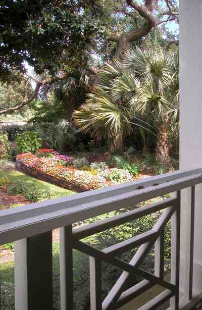 Pensacola:-Seville-Historic-District:-202-Cevallos-Street_27.jpg:  garden, palm trees, magnolia tree, oak trees, screen porch, victorian cottage, wooden decking, decorative balustrades, 