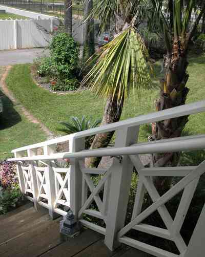 Pensacola:-Seville-Historic-District:-202-Cevallos-Street_29.jpg:  staircase, side stairs, back porch, palm tree, wooden steps, picket fence, victorian cottage