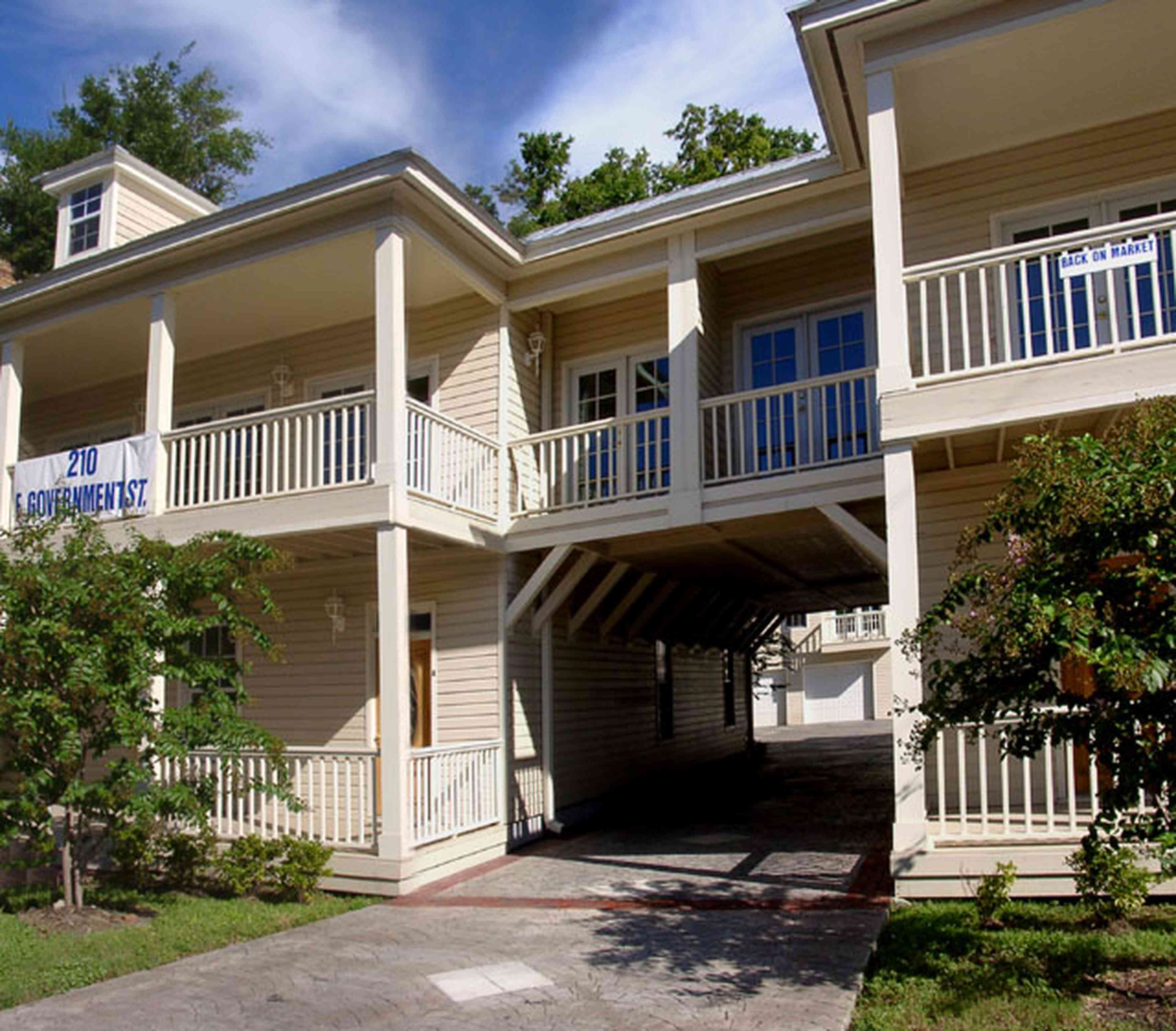 Pensacola:-Seville-Historic-District:-210-East-Government-Street_01.jpg:  multi-use building, crepe myrtle tree, condo, porches, french doors, carriage house, victorian building