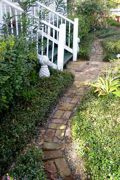 Pensacola:-Seville-Historic-District:-211-South-Florida-Blanca-Street_07.jpg:  pineapple finials, porch, garden