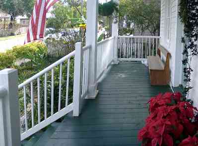 Pensacola:-Seville-Historic-District:-211-South-Florida-Blanca-Street_09.jpg:  poinsetta, deacons bench, porch, gulf coast cottage