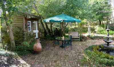 Pensacola:-Seville-Historic-District:-211-South-Florida-Blanca-Street_12.jpg:  umbrella, fountain, garden shed, brick patio