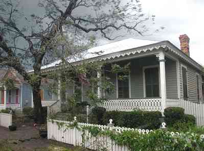 09-16-04+226+E+Intendencia+St_01+WEB.jpg:  Hurricane Ivan, white picket fence, pecan tree, shutters, clematis vine, sugar kettle, Victorian cottage, 