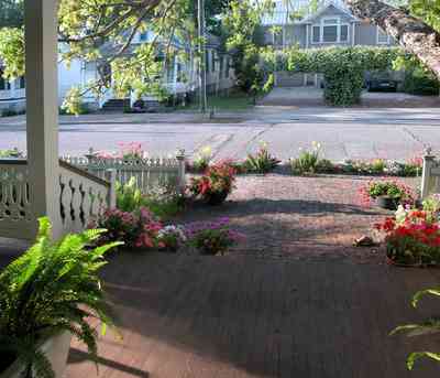 Pensacola:-Seville-Historic-District:-226-East-Intendencia-Street_03.jpg:  snapdragons, cabbages, ferns, pecan tree, peturnias, white picket fence, victorian front porch, pyramid roof, our-square georgian architectural style, victorian cottage, historic preservation, historic district, brick sidewalk, , 