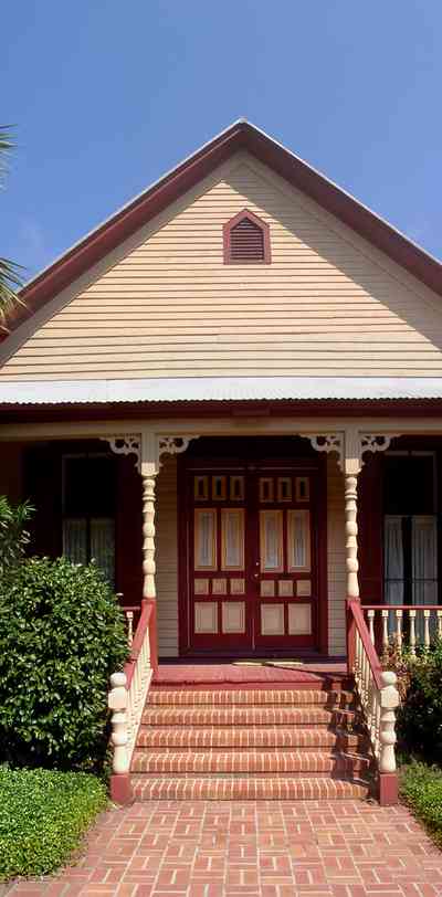 Pensacola:-Seville-Historic-District:-412-East-Government-Street_03.jpg:  victorian house, victorian front porch, historic district, brick sidewalk, gingerbread trim, historic district