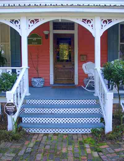 Pensacola:-Seville-Historic-District:-433-East-Zaragoza-Street_01.jpg Pensacola:-Seville-Historic-District:-433-East-Zaragoza-Street_01.jpg: victorian house, victorian front porch, wicker rocking chair, leaded stained glass, brick sidewalk