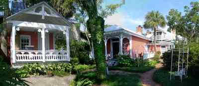 Pensacola:-Seville-Historic-District:-433-East-Zaragoza-Street_10.jpg:  victorian cottage, wicker furniture, victorian house, garden house, brick sidewalk, gingerbread trim, pyramidal roof, four-square georgian victorian house