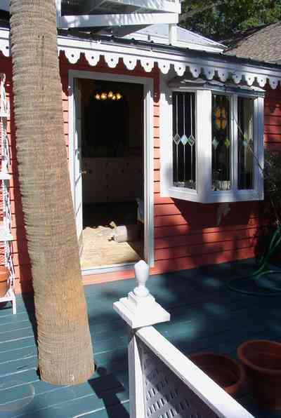 Pensacola:-Seville-Historic-District:-433-East-Zaragoza-Street_11a.jpg:  victorian house, four-square georgian house, palm tree, gingerbread trim, bay window, stained glass window, finial