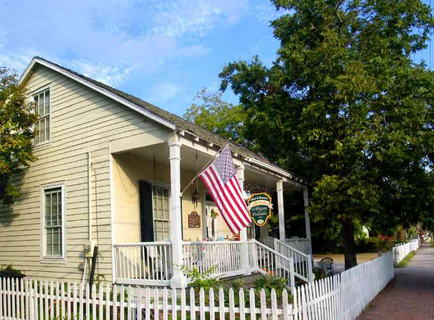 Pensacola:-Seville-Historic-District:-Chloe-And-Sophies-Attic_02.jpg:  white picket fence, victorian house, shingle roof, pecan tree, victorian front porch, , 