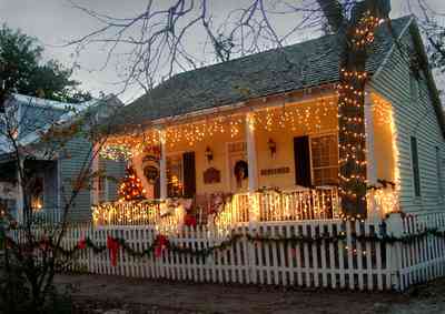 Pensacola:-Seville-Historic-District:-Chloe-And-Sophies-Attic_11.jpg:  christmas decorations, picket fence, pecan tree, garland, christmas tree