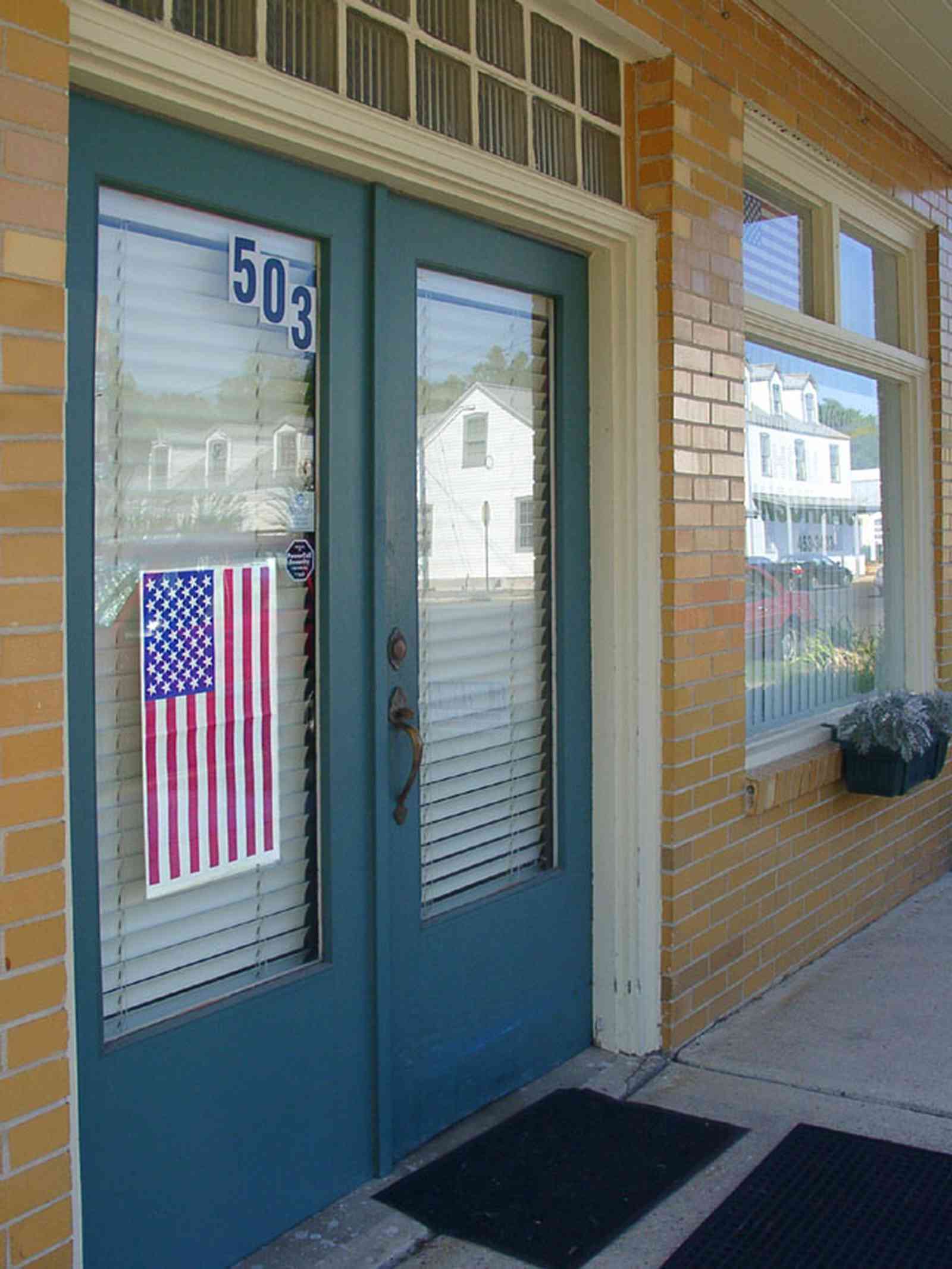 Pensacola:-Seville-Historic-District:-Complete-Music_--House_01.jpg:  brick building, american flag, art deco style