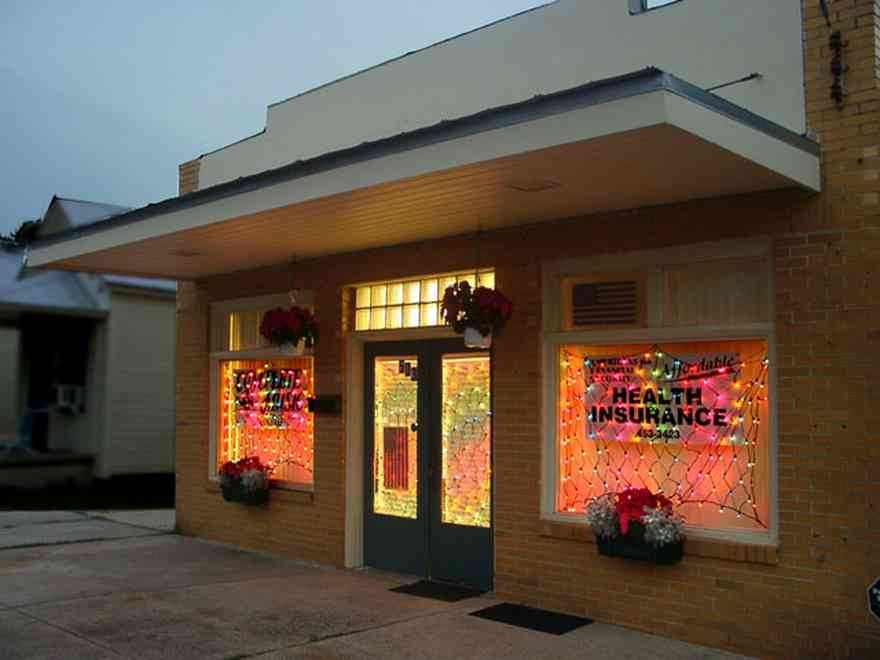 Pensacola:-Seville-Historic-District:-Complete-Music_02.jpg:  christmas decorations, curtain lights, poinsetta plants