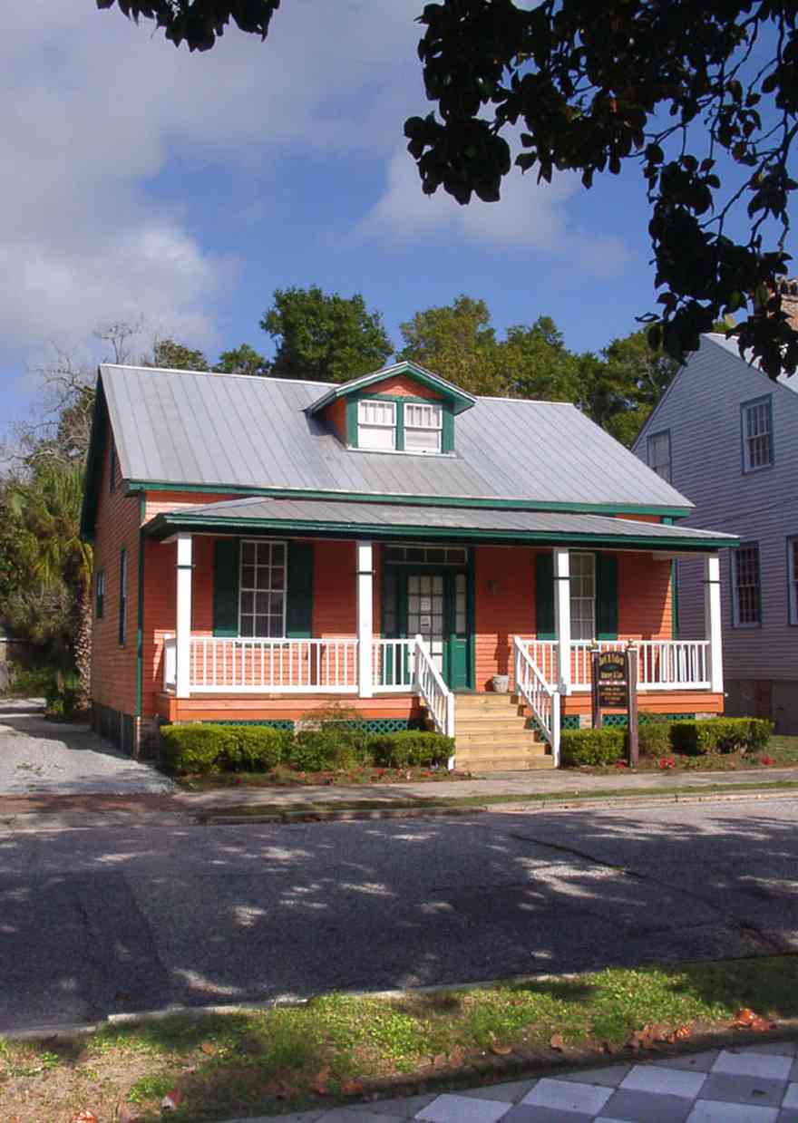 Pensacola:-Seville-Historic-District:-Joel-M.-Cohen,-P.A.-Attorney_01.jpg:  victorian cottage, porch, dormer, tiled sidewalk, magnolia tree, four-square georgian victorian cottage