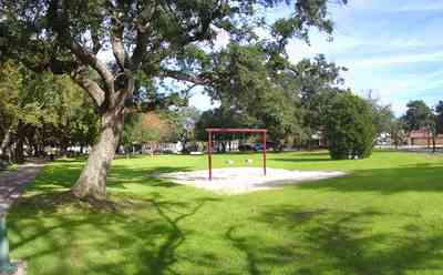 Pensacola:-Seville-Historic-District:-Seville-Square_01a.jpg:  childrens swing, cedar tree, oak tree
