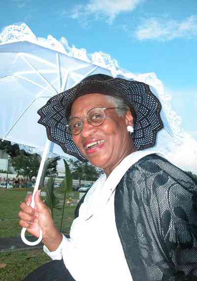 Pensacola:-Seville-Historic-District:-St-Michael-Cemetery_31.jpg:  creole, parasol, umbrella, shawl, straw hat, grave