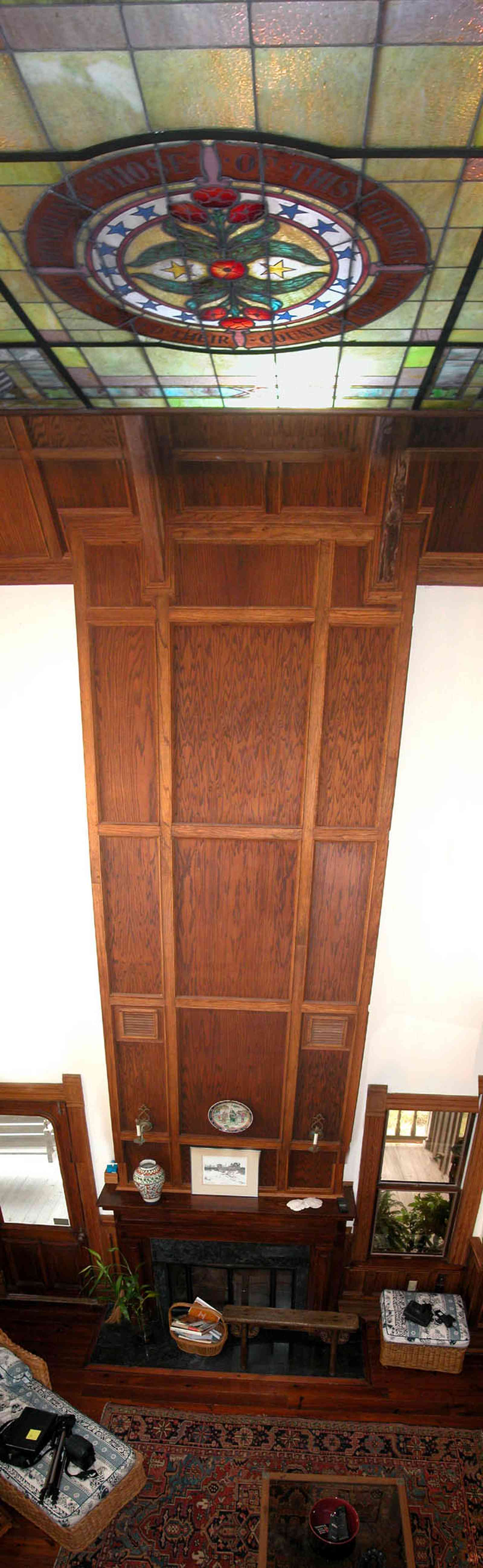 Perdido-Key:-Gothic-House_08s.jpg:  great room, living room, oriental rug, mantle, fireplace, stained glass window, wicker sofa