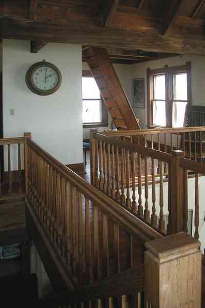 Perdido-Key:-Gothic-House_08t.jpg Perdido-Key:-Gothic-House_08t.jpg: staircase, ship's clock, second floor, heartpine lumber,