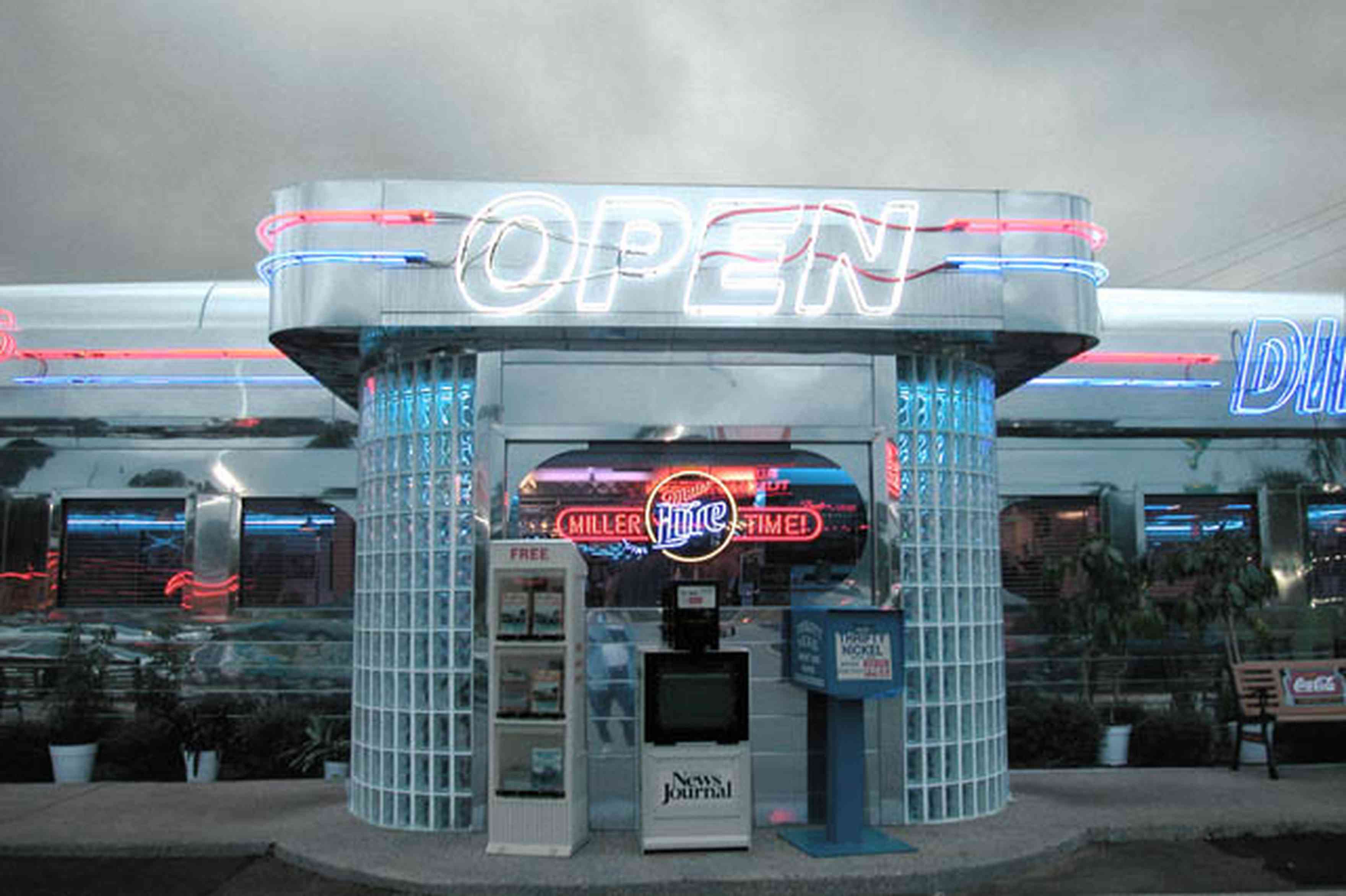Pine-Forest:-50s-Diner_02.jpg:  neon sign, 1950 style, glass blocks, newspaper stand, stainless steel, park bench, hamburgers, green fried tomatoes