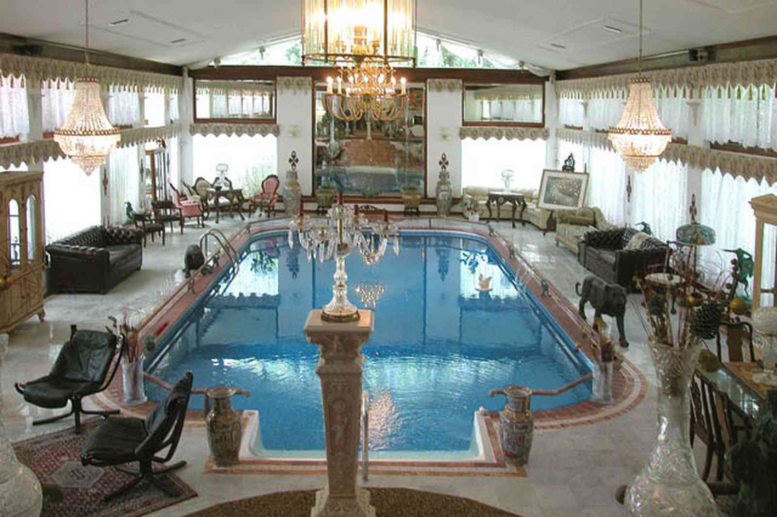 Scenic-Highway:-3780-Scenic-Ridge-Drive_04.jpg:  olympic swimming pool, living room, marble floors, chinese urns, tassels, oriental rug, pool in livingroom, inside swimming pool, french provincial furniture, crystal chandelier, swag curtains