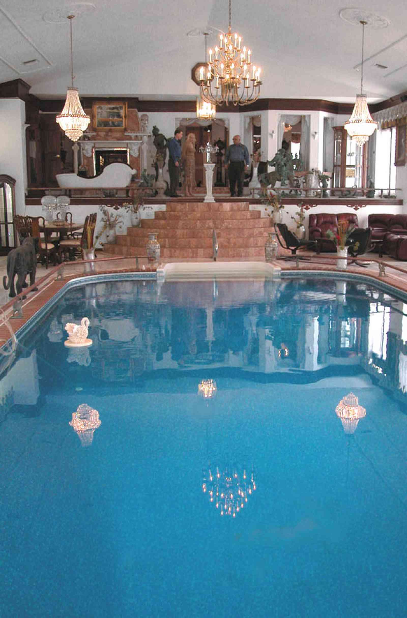 Scenic-Highway:-3780-Scenic-Ridge-Drive_05.jpg:  olympic swimming pool, living room, marble floors, chinese urns, tassels, oriental rug, pool in livingroom, inside swimming pool, french provincial furniture, crystal chandelier, reflection in pool, swan in water, marble steps, swag curtains