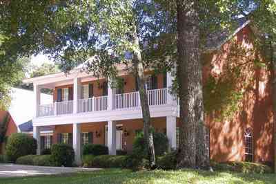 Scenic-Highway:-4540-Bohemia-Drive_03.jpg:  colonial architectural style, front porch, gable, oak tree, circular driveway, red brick