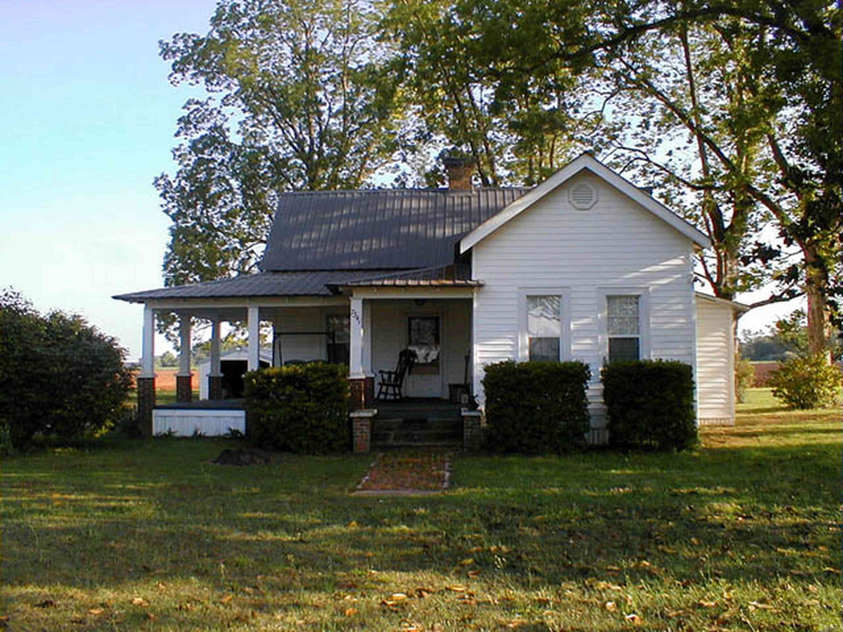 Walnut-Hill:-Ward-Farm_04.jpg:  farmland, craftsman style home, oak tree, magnolia tree, highway 97, corn field, menonite religious community, two-lane road, curving road, escambia county
