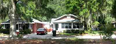 East-Pensacola-Heights:-118-Bayou-Blvd_06.jpg:  craftsman cottage, spanish moss, bayou texar, oak tree, red brick house