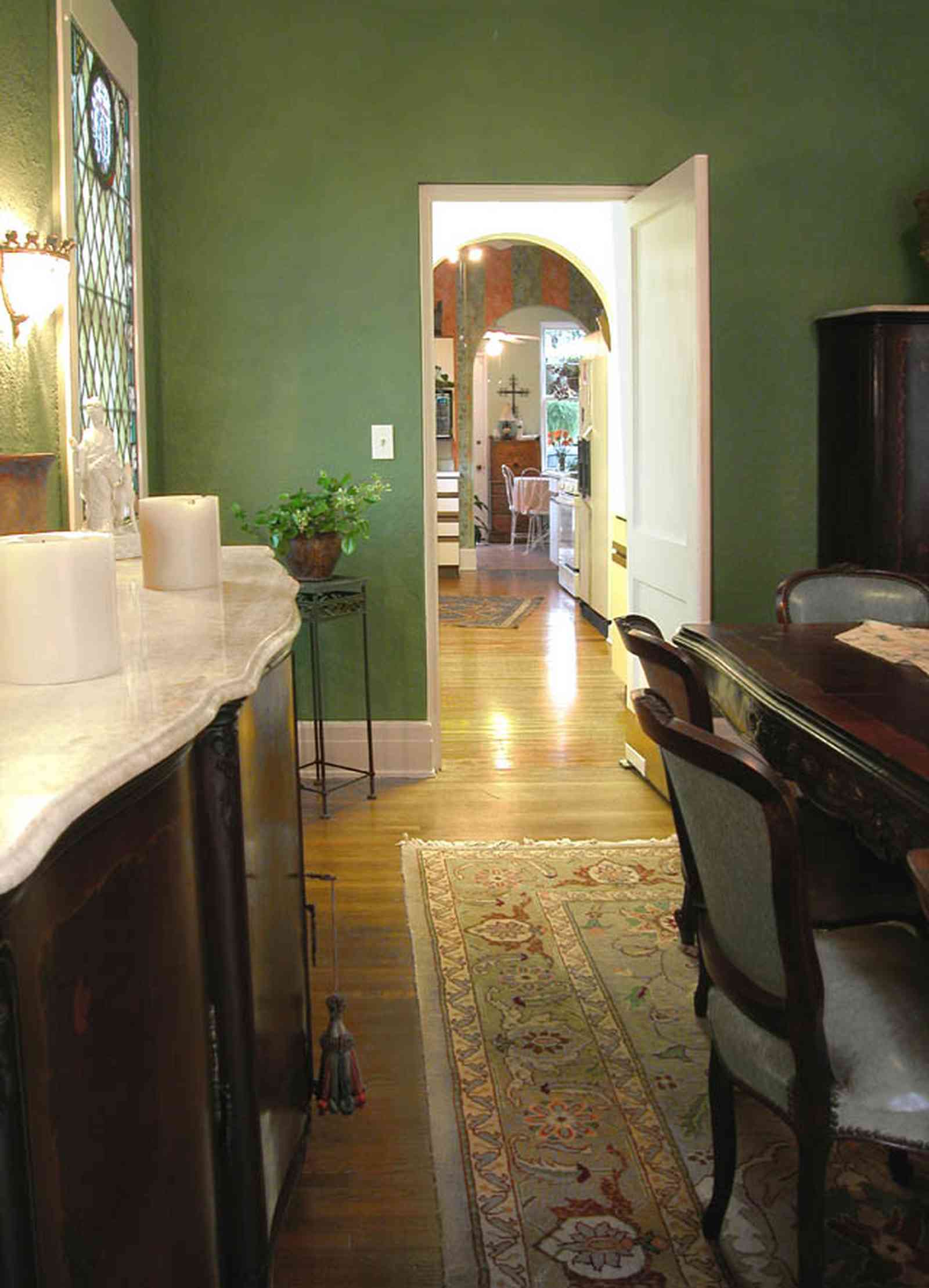 North-Hill:-123-West-Lloyd-Street_18.jpg:  dining room, kitchen, breakfast room, oriental rug, buffet, dining room table, stained glass window, 