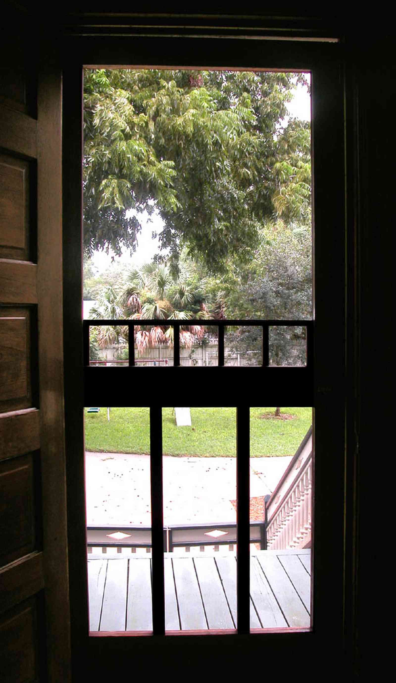 North-Hill:-304-West-Gadsden-Street_10.jpg:  screen door. pecan tree, side porch, heartpine door, north hill preservation district