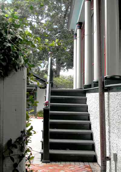 North-Hill:-304-West-Gadsden-Street_24.jpg:  brick sidewalk, stairs, columns, picket fence, pool house, magnolia tree