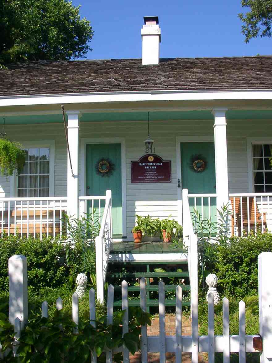 Pensacola:-Seville-Historic-District:-211-South-Florida-Blanca-Street_00.jpg:  creole cottage, picket fence, porch, wood shingle roof