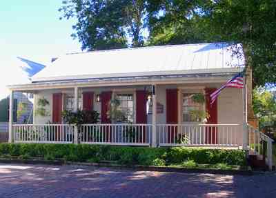 Pensacola:-Seville-Historic-District:-Lisa-Minshew-Attorney_01.jpg:  creole cottage, historic district, american flag, porch